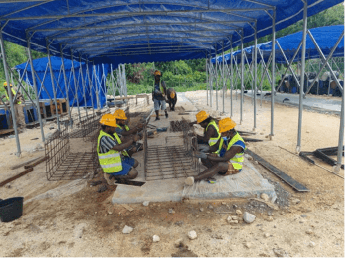 A-team-of-local-workers-meticulously-assembles-rebar-cages-showcasing-technical-construction-skills